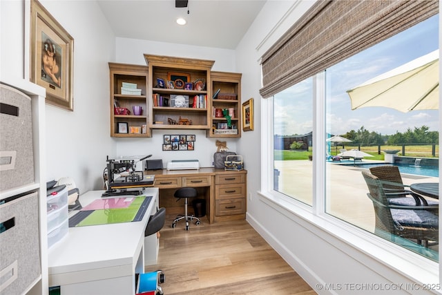 office space with baseboards, light wood-style floors, and recessed lighting