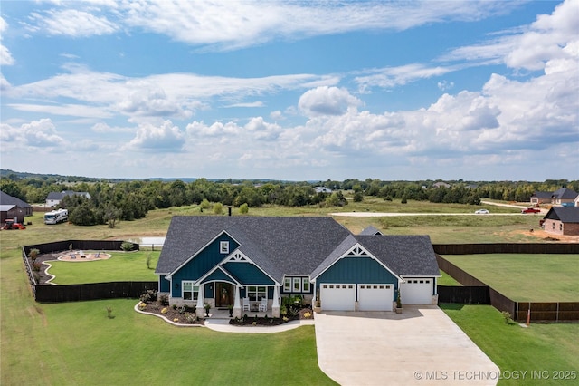view of front facade featuring fence, concrete driveway, board and batten siding, a front yard, and a garage