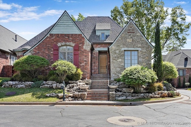 10135 S 78th E Ave, Tulsa, OK 74133 - english style home featuring brick siding, entry steps, stone siding, and a shingled roof
