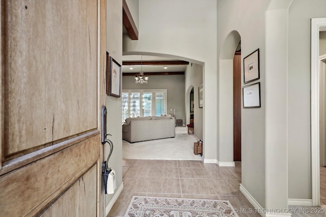 10135 S 78th E Ave, Tulsa, OK 74133 - corridor featuring arched walkways, a notable chandelier, light colored carpet, and light tile patterned flooring