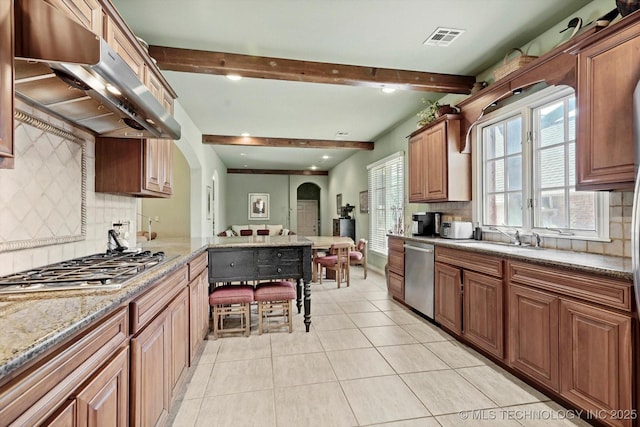 10135 S 78th E Ave, Tulsa, OK 74133 - kitchen with stainless steel appliances, extractor fan, visible vents, arched walkways, and tasteful backsplash