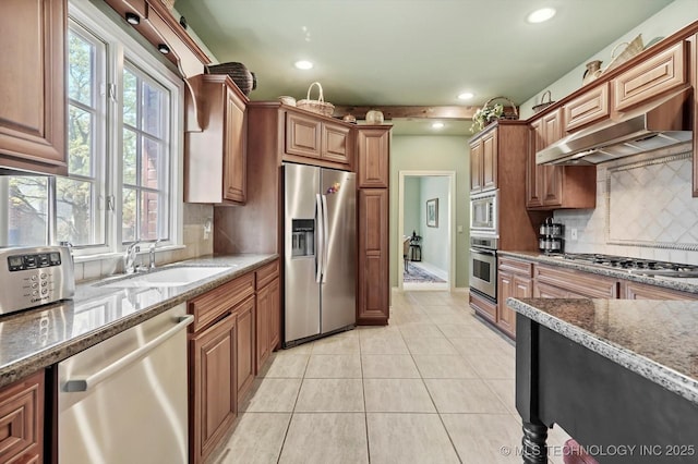 10135 S 78th E Ave, Tulsa, OK 74133 - kitchen with under cabinet range hood, stainless steel appliances, backsplash, a sink, and light tile patterned flooring