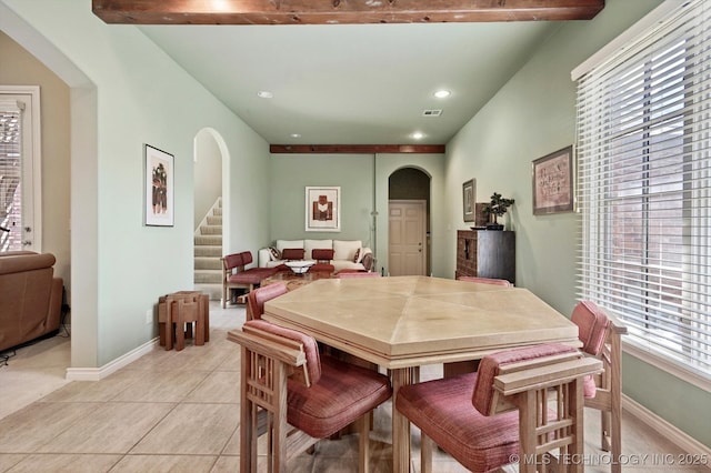 10135 S 78th E Ave, Tulsa, OK 74133 - dining space with arched walkways, baseboards, stairs, and light tile patterned flooring