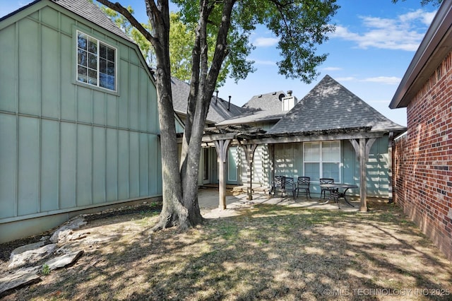 10135 S 78th E Ave, Tulsa, OK 74133 - exterior space with board and batten siding, a patio area, and roof with shingles
