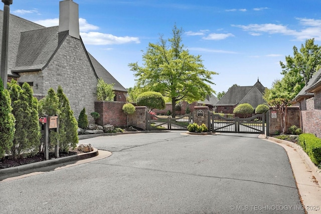 10135 S 78th E Ave, Tulsa, OK 74133 - view of street with a gate, a gated entry, and curbs