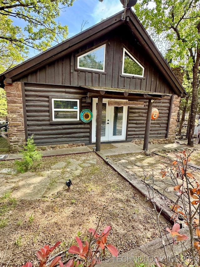 139 N Bk 1800 Rd, Stigler, OK 74462 - view of front facade with board and batten siding, french doors, and log siding