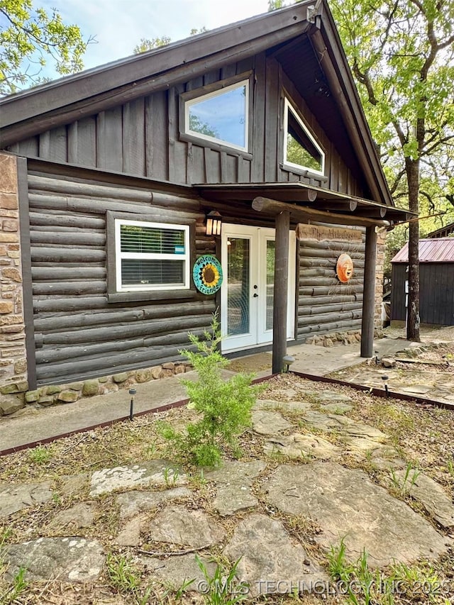139 N Bk 1800 Rd, Stigler, OK 74462 - log-style house featuring board and batten siding, french doors, an outbuilding, and log exterior