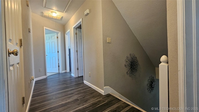 506 S Delaware Ave, Okmulgee, OK 74447 - hallway with attic access, baseboards, a textured wall, and dark wood finished floors
