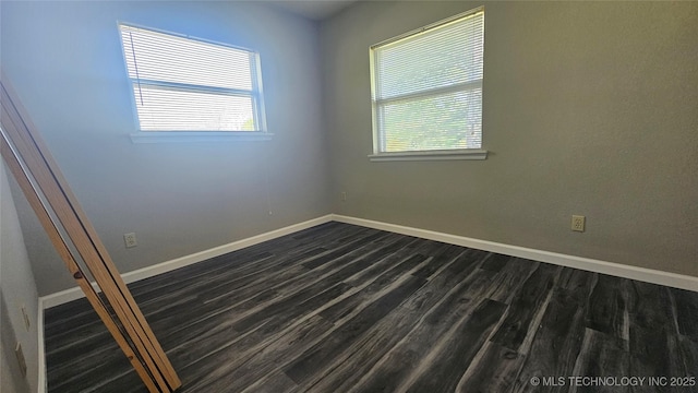 506 S Delaware Ave, Okmulgee, OK 74447 - spare room with baseboards and dark wood-type flooring