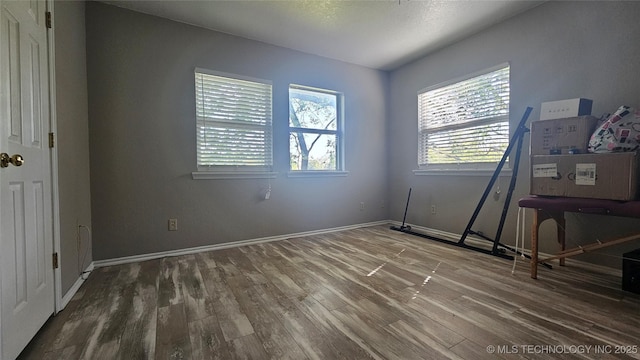 506 S Delaware Ave, Okmulgee, OK 74447 - unfurnished bedroom featuring wood finished floors and baseboards