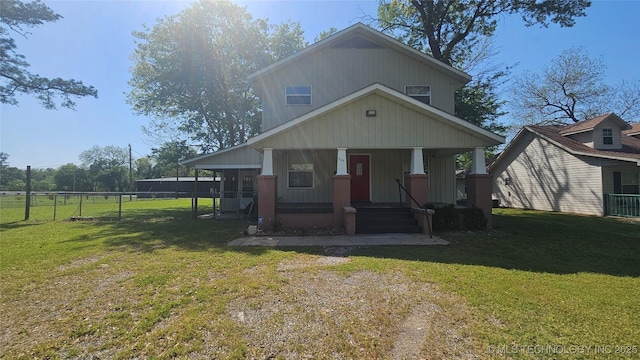 506 S Delaware Ave, Okmulgee, OK 74447 - view of front of house with fence, a porch, and a front yard