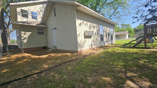 506 S Delaware Ave, Okmulgee, OK 74447 - view of side of home with fence, a playground, a yard, and entry steps