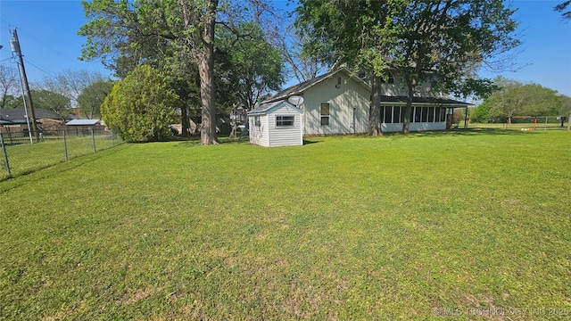 506 S Delaware Ave, Okmulgee, OK 74447 - view of yard with an outdoor structure, a storage unit, a sunroom, and a fenced backyard