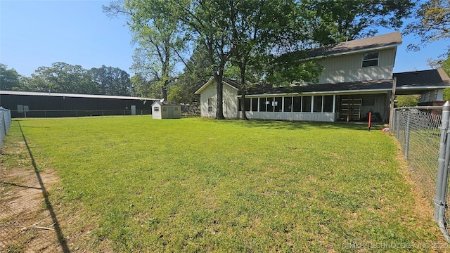506 S Delaware Ave, Okmulgee, OK 74447 - view of yard with a fenced backyard, an outdoor structure, a sunroom, and a storage unit