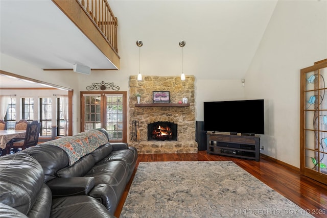 10421 S Richmond Pl, Tulsa, OK 74137 - living area with wood finished floors, a towering ceiling, baseboards, and a stone fireplace
