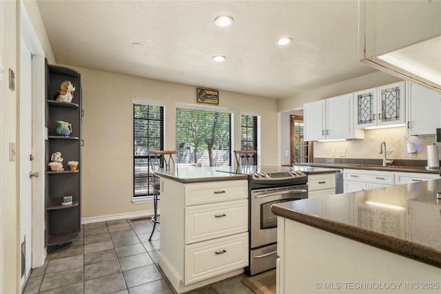 10421 S Richmond Pl, Tulsa, OK 74137 - kitchen with open shelves, decorative backsplash, stainless steel electric range oven, white cabinets, and recessed lighting