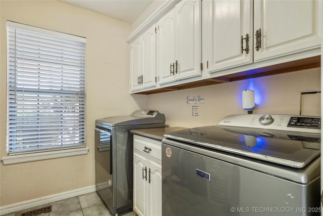 10421 S Richmond Pl, Tulsa, OK 74137 - laundry room with visible vents, light tile patterned floors, baseboards, separate washer and dryer, and cabinet space