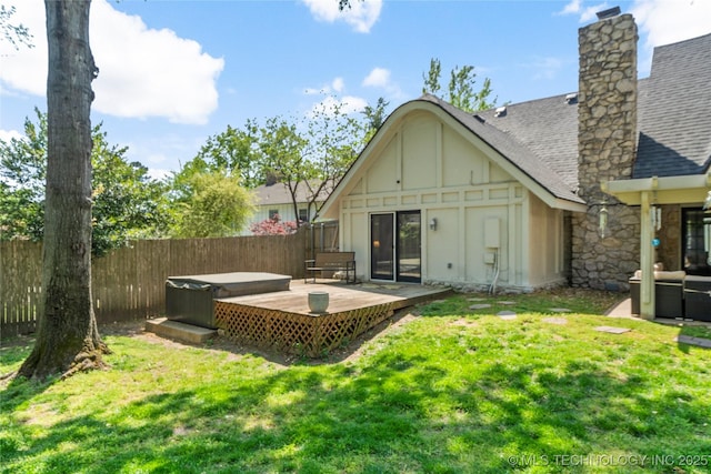 10421 S Richmond Pl, Tulsa, OK 74137 - back of property with roof with shingles, a chimney, fence private yard, a hot tub, and a deck