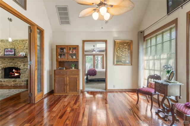 10421 S Richmond Pl, Tulsa, OK 74137 - living area featuring a stone fireplace, ceiling fan, light wood-style flooring, baseboards, and visible vents