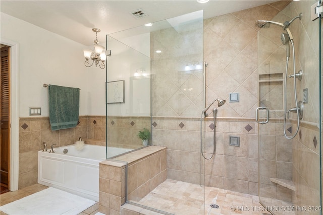10421 S Richmond Pl, Tulsa, OK 74137 - full bathroom featuring a garden tub, a notable chandelier, visible vents, and a stall shower