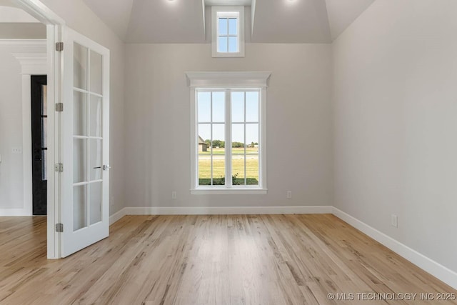 empty room with light wood-style flooring and baseboards