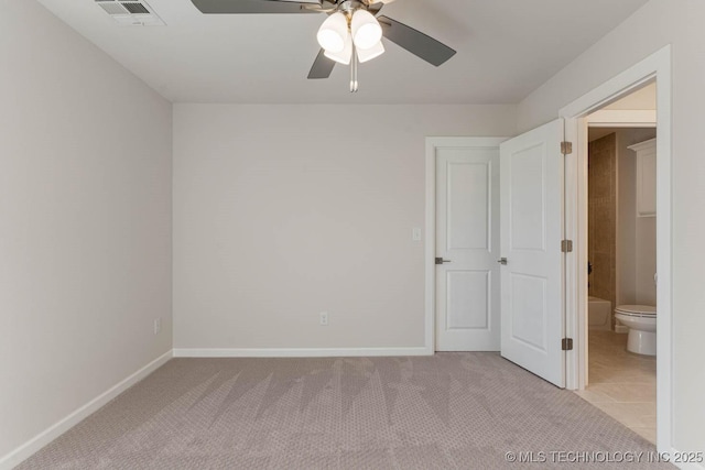 unfurnished bedroom with light colored carpet, ceiling fan, baseboards, and visible vents