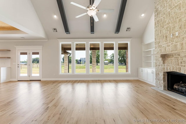 unfurnished living room with a ceiling fan, built in features, a fireplace, baseboards, and visible vents