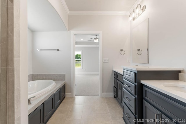 full bath featuring a garden tub, a ceiling fan, crown molding, vanity, and baseboards