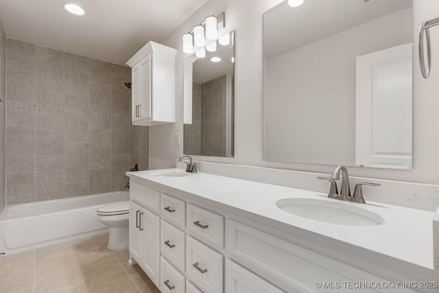 bathroom with a sink, recessed lighting, double vanity, and toilet