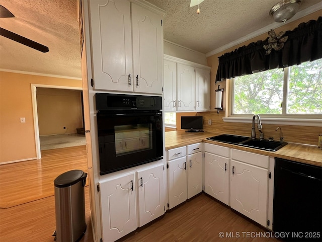 1380 N Lakeview Ave, Mannford, OK 74044 - kitchen with a textured ceiling, a sink, black appliances, ornamental molding, and dark wood-type flooring