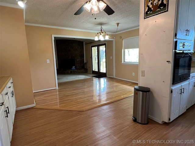 1380 N Lakeview Ave, Mannford, OK 74044 - interior space featuring ornamental molding, a textured ceiling, a ceiling fan, and wood finished floors