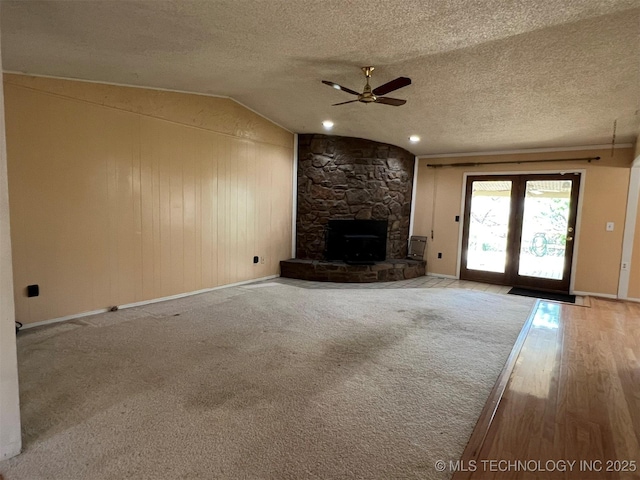 1380 N Lakeview Ave, Mannford, OK 74044 - unfurnished living room with a textured ceiling, ceiling fan, vaulted ceiling, and baseboards
