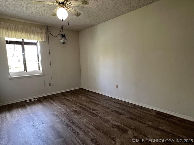 1380 N Lakeview Ave, Mannford, OK 74044 - unfurnished room with ceiling fan, a textured ceiling, baseboards, visible vents, and dark wood-style floors