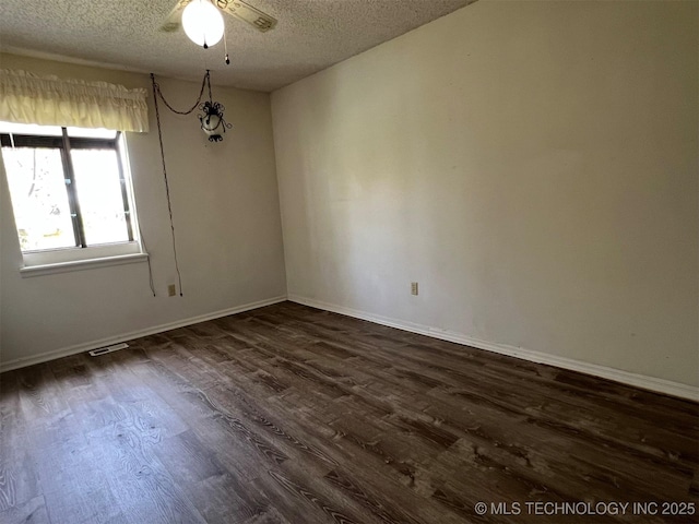 1380 N Lakeview Ave, Mannford, OK 74044 - unfurnished room with ceiling fan, dark wood-style flooring, a textured ceiling, and visible vents