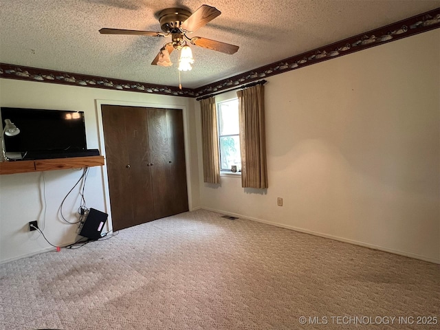 1380 N Lakeview Ave, Mannford, OK 74044 - unfurnished bedroom featuring carpet flooring, ceiling fan, a textured ceiling, baseboards, and a closet