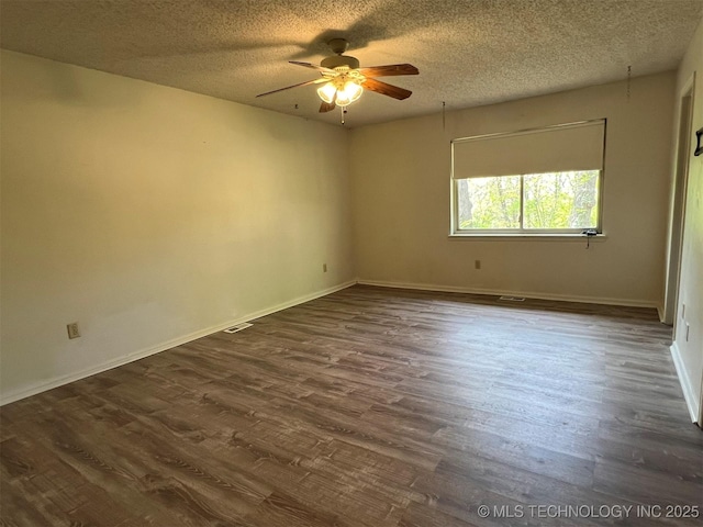 1380 N Lakeview Ave, Mannford, OK 74044 - empty room with dark wood-type flooring, a ceiling fan, a textured ceiling, and baseboards