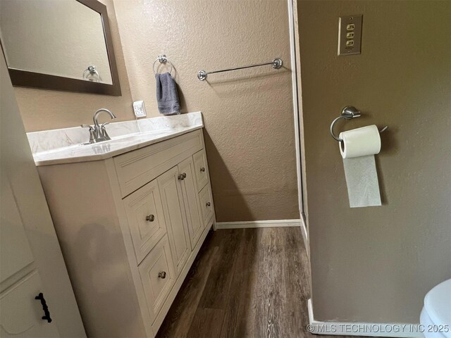 1380 N Lakeview Ave, Mannford, OK 74044 - bathroom with vanity, baseboards, toilet, and wood finished floors