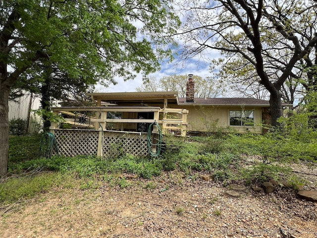 1380 N Lakeview Ave, Mannford, OK 74044 - rear view of property with a chimney and stucco siding