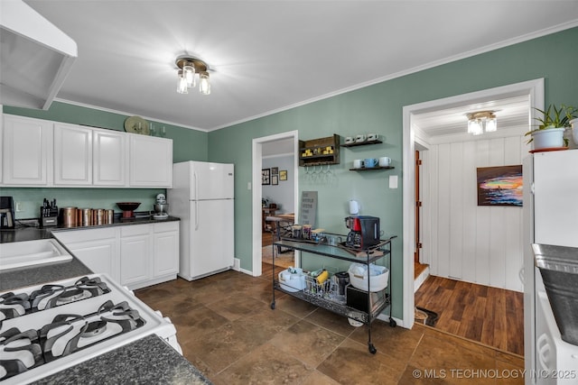 4222 E 25th St, Tulsa, OK 74114 - kitchen featuring white appliances, dark countertops, white cabinetry, ornamental molding, and a sink