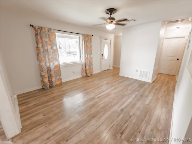 322 E Maple St, Skiatook, OK 74070 - empty room with baseboards, visible vents, wood finished floors, and ceiling fan