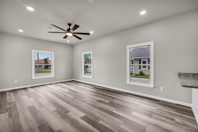 unfurnished room with a ceiling fan, wood finished floors, baseboards, visible vents, and recessed lighting