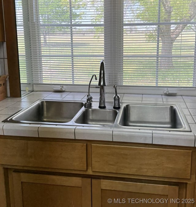 402325 W 2100th Rd, Bartlesville, OK 74006 - kitchen with a sink, light countertops, brown cabinets, and plenty of natural light