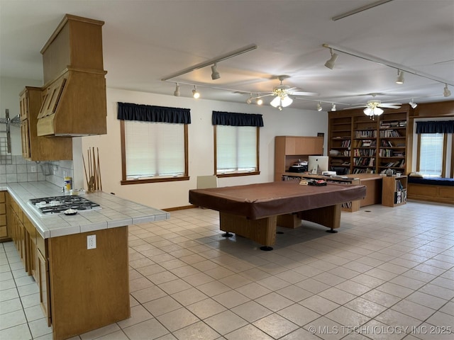 playroom with billiards, track lighting, light tile patterned floors, and a ceiling fan