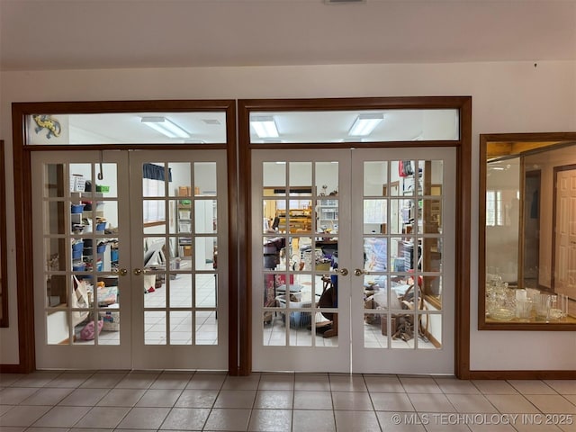 doorway to outside featuring french doors, visible vents, and light tile patterned floors