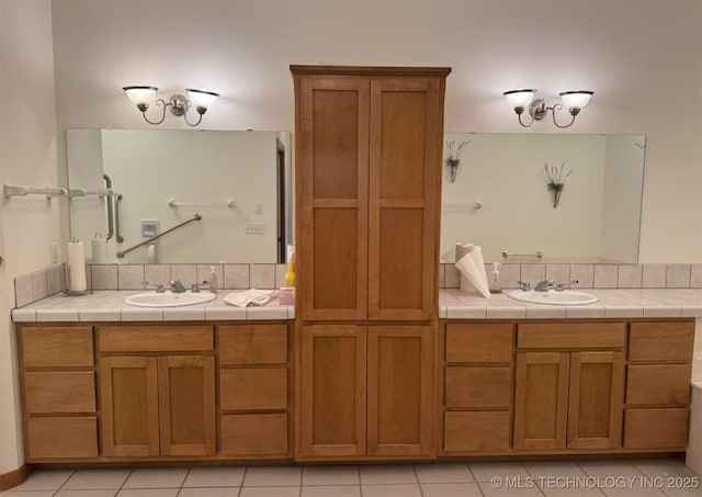 full bathroom featuring tile patterned flooring, a sink, and double vanity