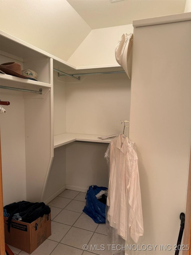 walk in closet featuring light tile patterned flooring
