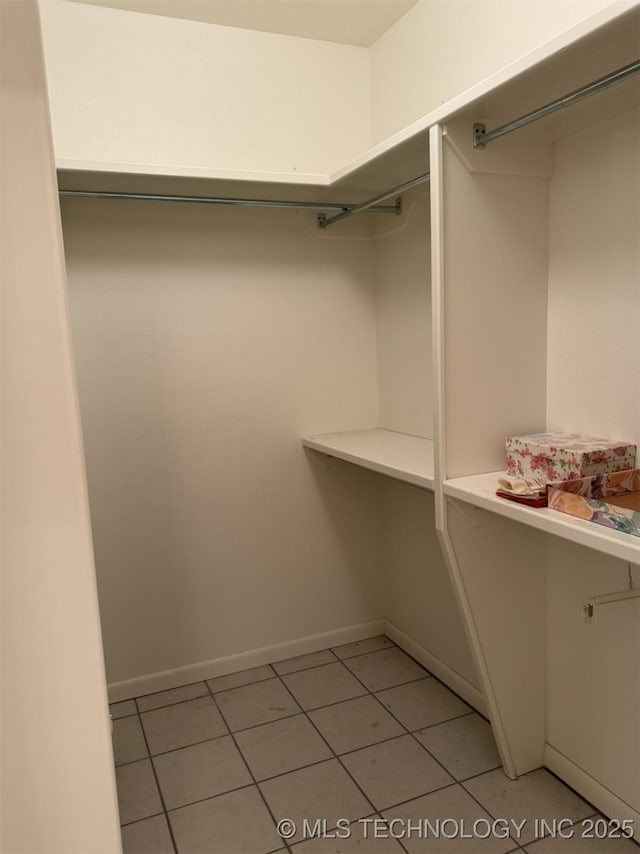 spacious closet featuring light tile patterned floors