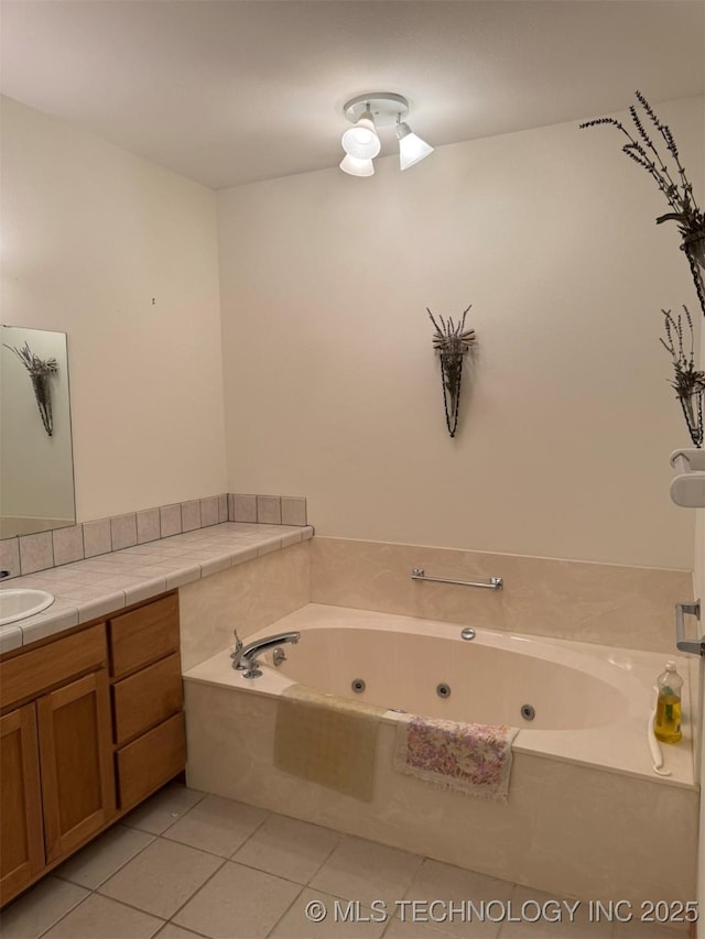 bathroom featuring vanity, tile patterned floors, and a jetted tub
