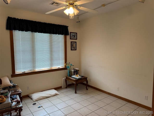 spare room featuring light tile patterned floors, baseboards, visible vents, and ceiling fan