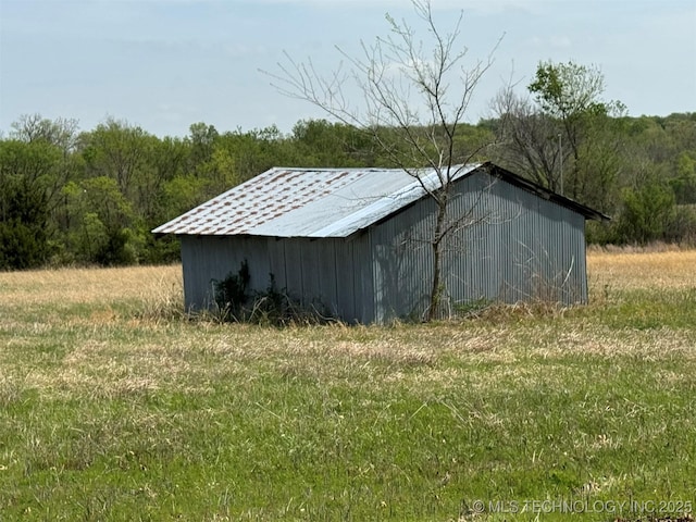 view of pole building with a forest view